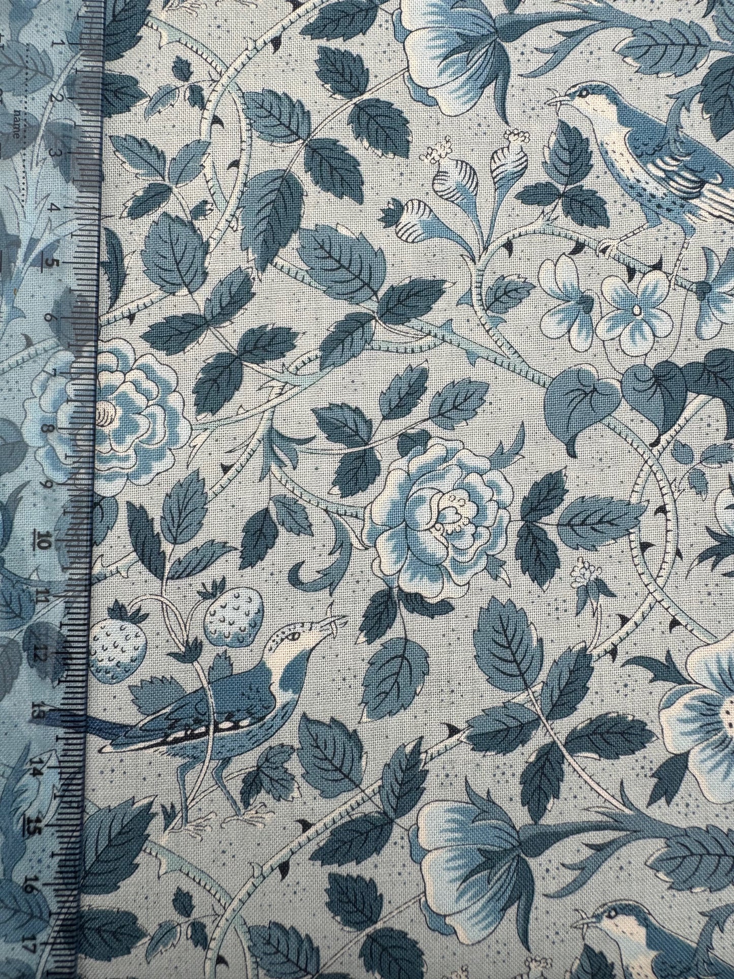 Floral and leaf pattern with birds on a light blue background
