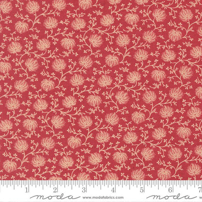 Floral patterned fabric with a ruler at the bottom for scale, on a red background.
