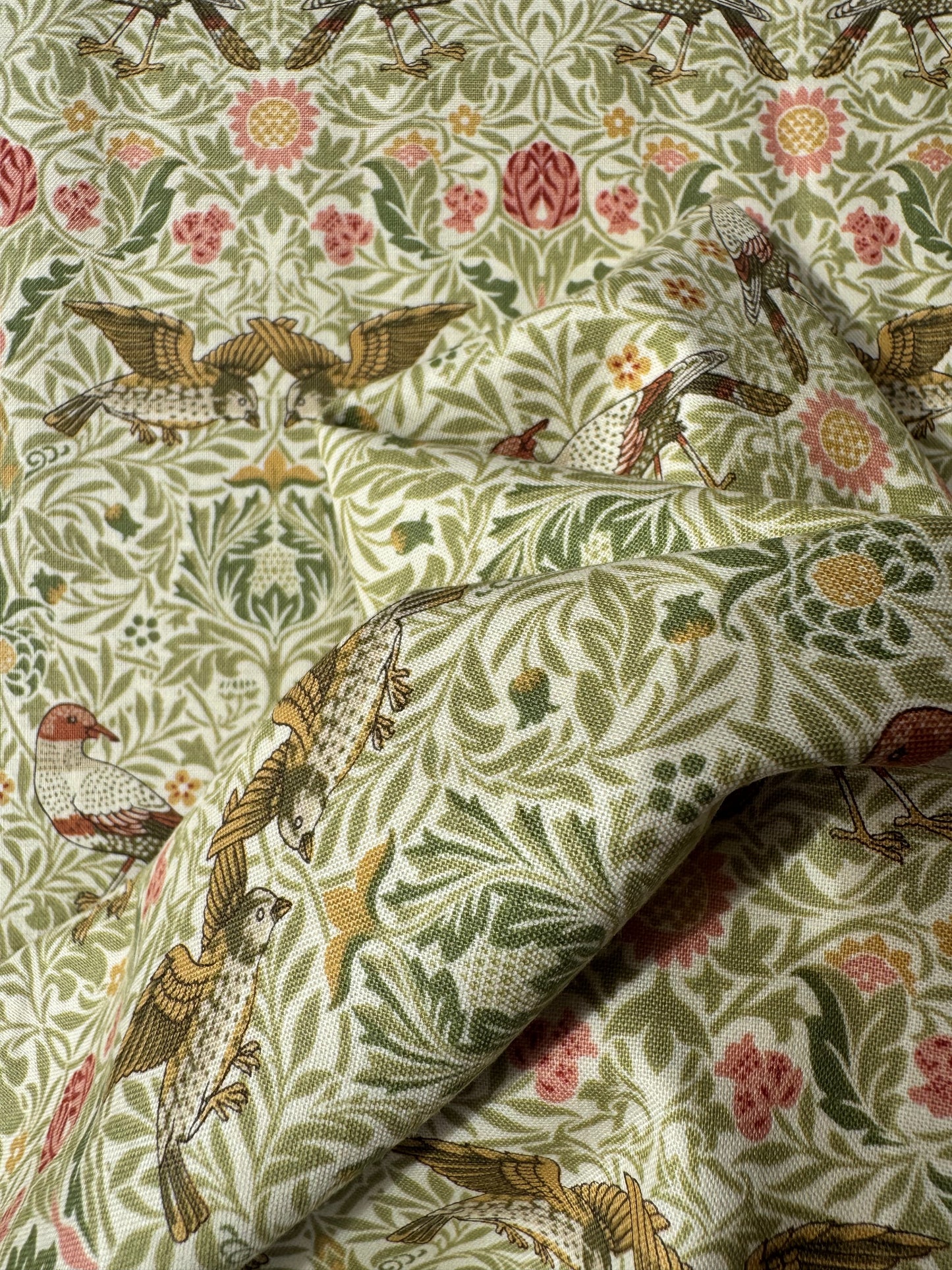 Fabric with bird and floral pattern, featuring a close-up of the texture.