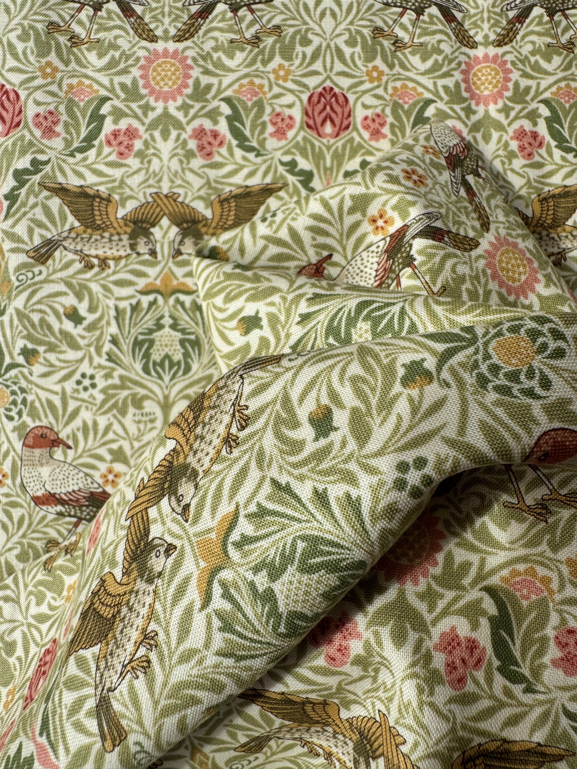 Fabric with bird and floral pattern, featuring a close-up of the texture.