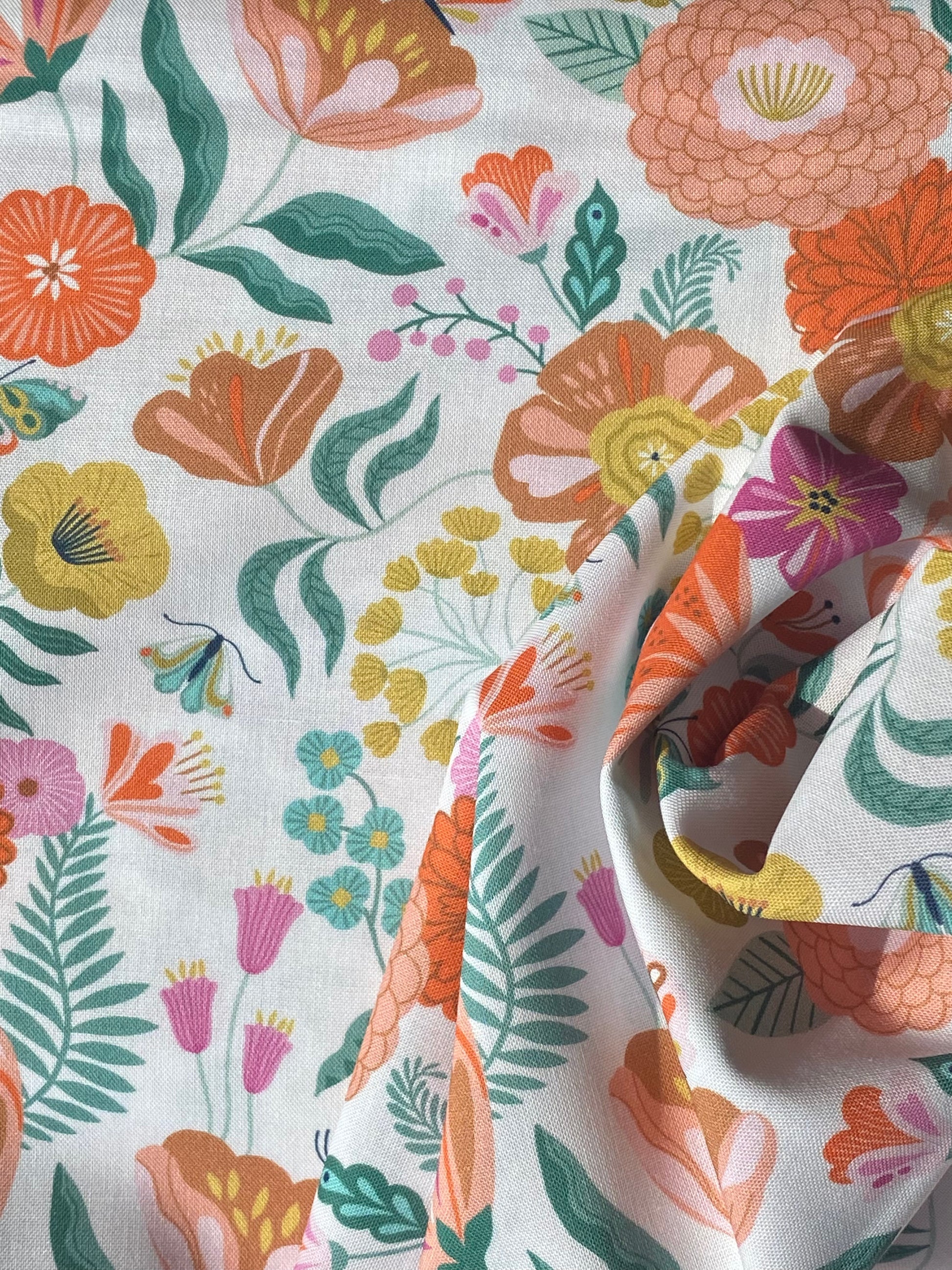 FLUT2075 Colourful flowers on a white cotton fabric designed by Bethan Janine for Dashwood Studios.  It is ideal for patchwork, quilting, patchwork, dressmaking and other crafts. Free delivery over £30.